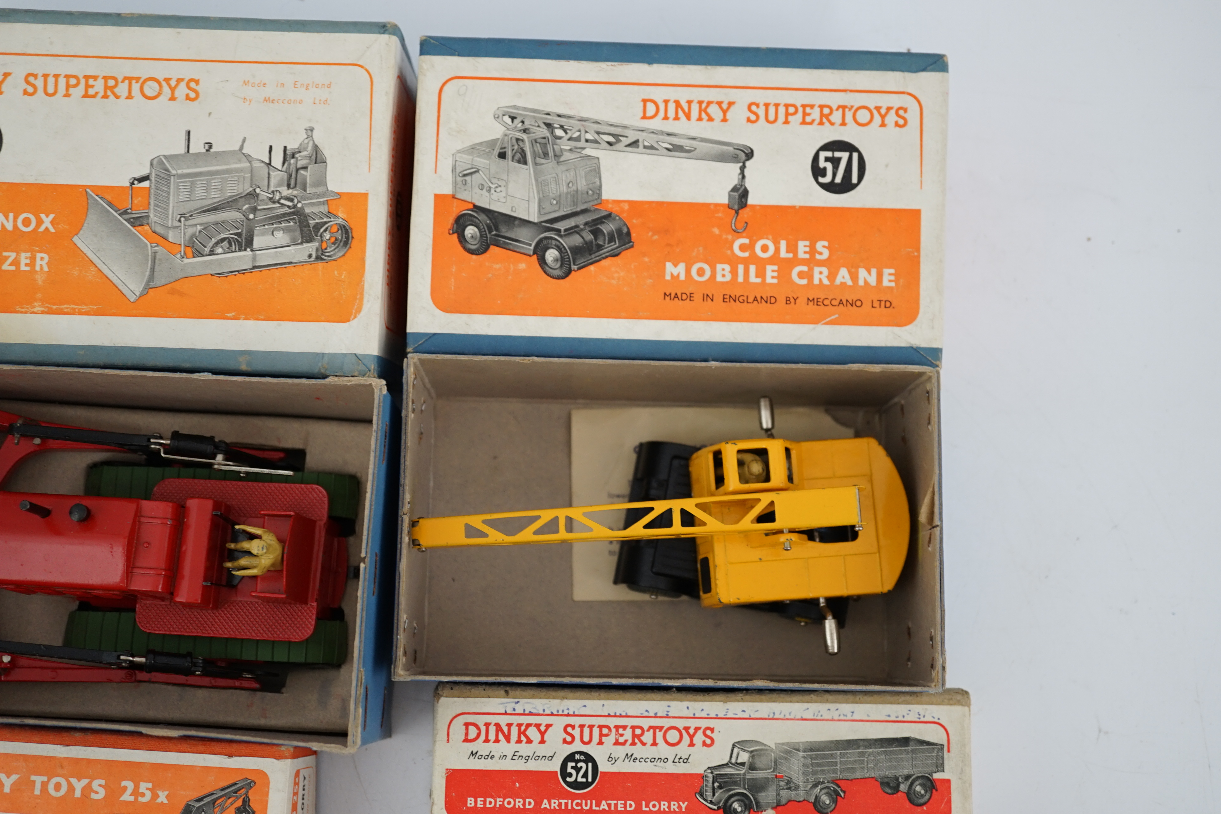 Five boxed Dinky Supertoys and Dinky Toys; a Breakdown Lorry (25x) dark grey with dark blue back, a Bedford Articulated Lorry (521) in yellow, a Blaw Knox Bulldozer (561) In red with green rubber tracks, a Dumper Truck (